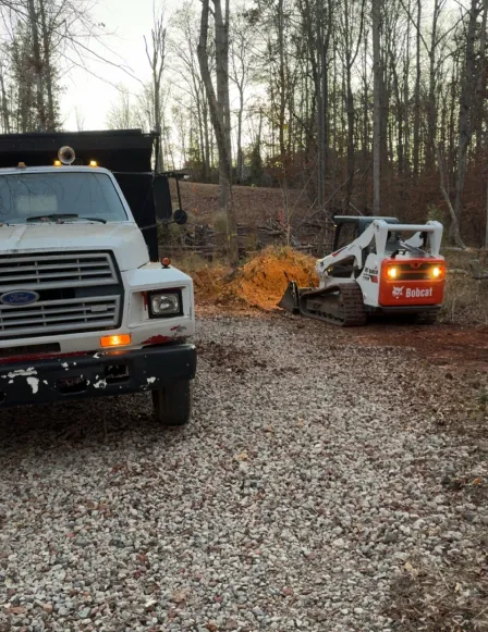 grading land clearing bobcat beside truck walnut cove nc